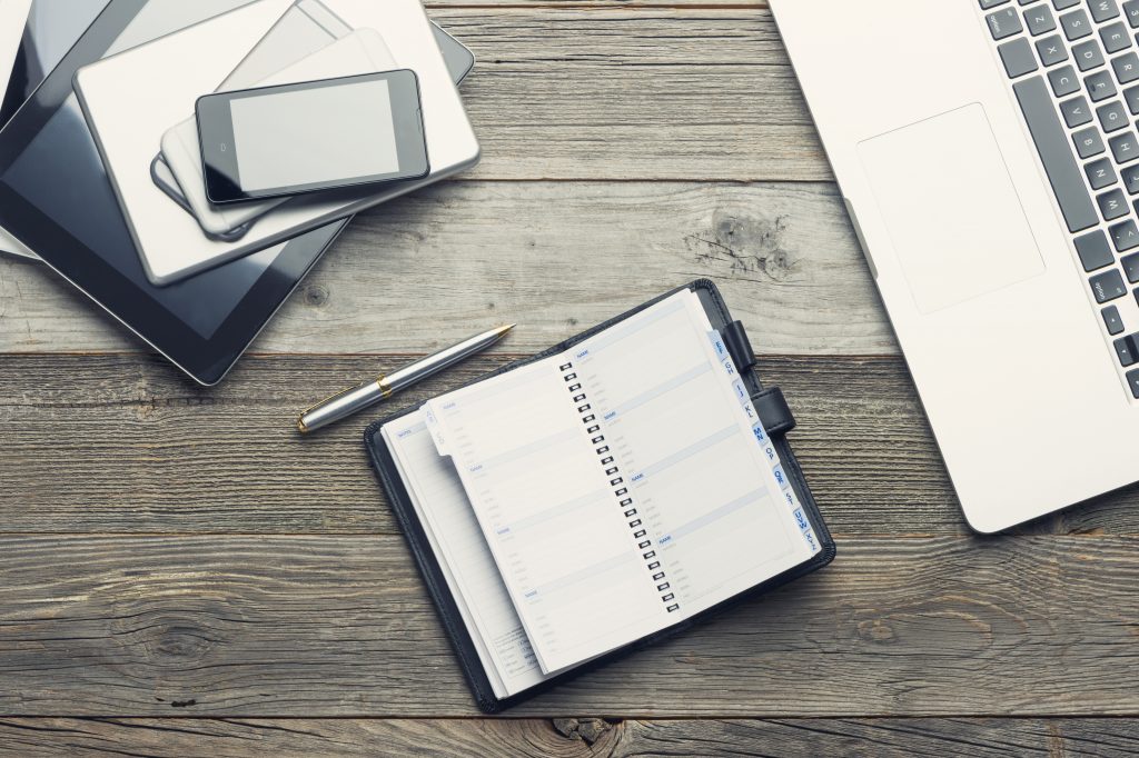desk with phone laptop and planner iStock 485373522 business expenses insurance