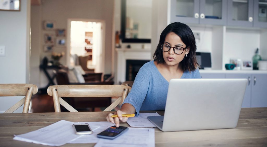 Tax and Accounting for Private Practice 2 tax accounting for doctors; accountants for medical practitioners; accountants for doctors; lady sitting at table with computer and calculator doing taxes