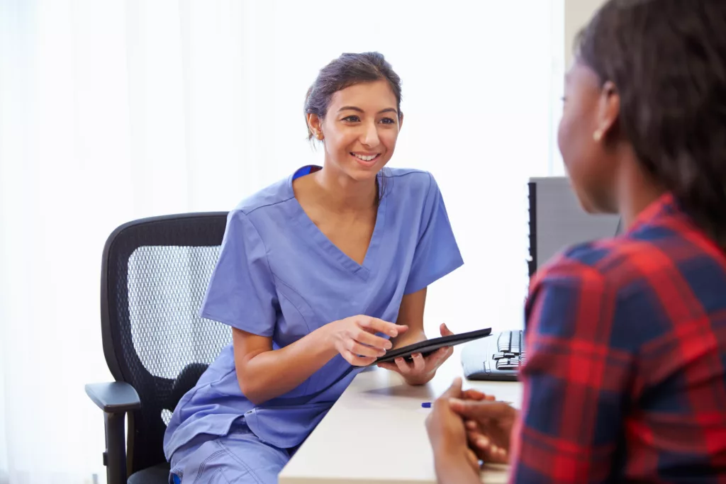 What tax deductions can you claim as a locum doctor? 68 young female doctor with patient iStock 489341812