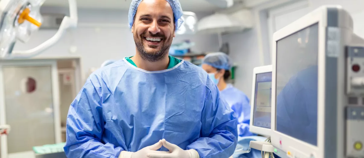 Anaesthetist Group Structure Review Offer 1 Anesthetist Working In Operating Theatre Wearing Protecive Gear checking monitors while sedating patient before surgical procedure in hospital